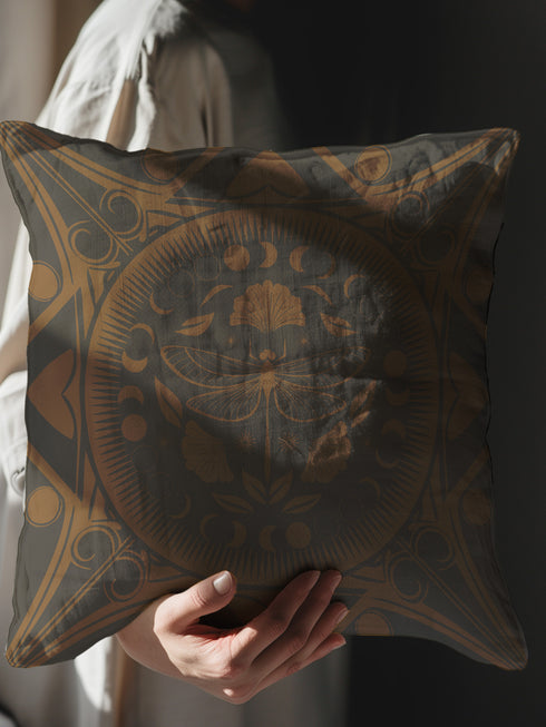 Square pillow cover featuring a detailed copper dragonfly illustration centered in a circular medallion with moon phases and Art Deco geometric patterns on a dark gray background.